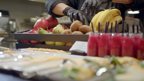 Arranging fresh fruit for breakfast in fancy restaurant Stock Footage 99400797