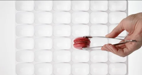 Arranging macaroons on display Stock Footage 128598310
