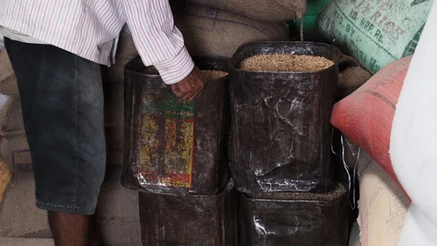 Arranging old metal containers full of rice in storage room, rice mill 库存影片 112254155