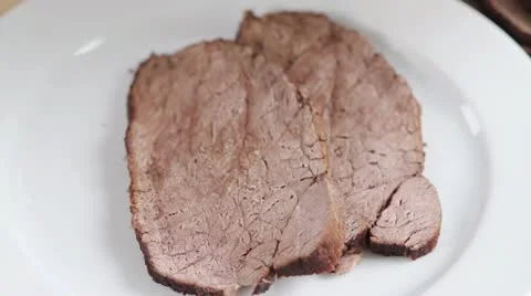 Arranging roast beef with jus Stock Footage 24664048