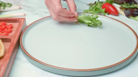 Arranging in a serving plate Seared Tuna with decorative vegetables in 4K. Stock Footage 141310376