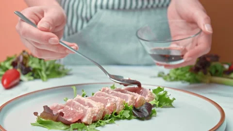 Arranging in a serving plate Seared Tuna with decorative vegetables in 4K. Stock Footage 141311386