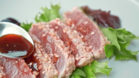 Arranging in a serving plate Seared Tuna with decorative vegetables in 4K. Stock Footage 141311646