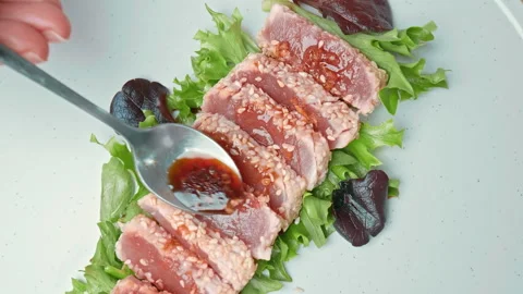 Arranging in a serving plate Seared Tuna with decorative vegetables in 4K. Stock Footage 141311964