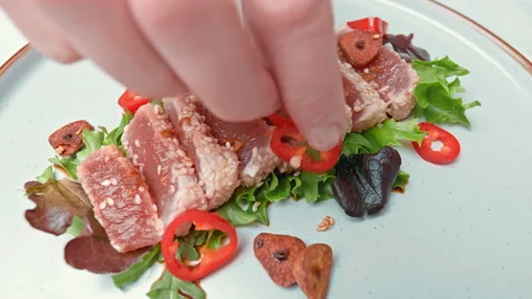 Arranging in a serving plate Seared Tuna with decorative vegetables in 4K. Stock Footage 141312476