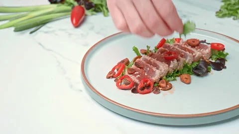Arranging in a serving plate Seared Tuna with decorative vegetables in 4K. Stock Footage 141312797
