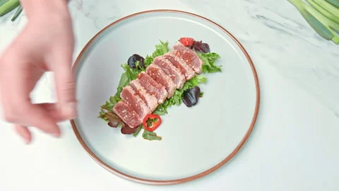Arranging in a serving plate Seared Tuna with decorative vegetables in 4K. Stock Footage 141312845