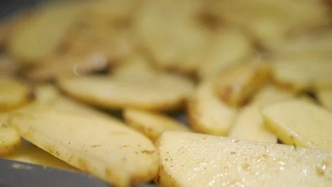 Arranging Sliced Potatoes in a Cozy Kitchen | HLG Stock Footage 303385401
