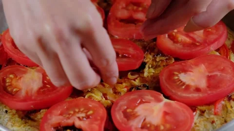 Arranging Tomato Slices on Savory Base in Cooking Pan Stock-Footage 341441299