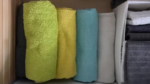 Arranging towel colors and textures in drawer Stock-Footage 343864146