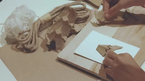 Arranging triangle shape recycled egg tray cut out to form a Christmas tree Video stock 297454394