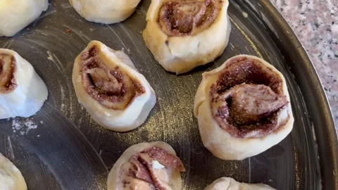 Arranging Unbaked Cinnamon Rolls in a Baking Pan Stock Footage 345522441