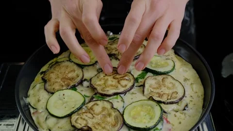 Arranging Vegetable Slices in Batter Skillet Cooking Video stock 341421383