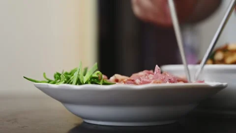 Arranging Yilan Cured Duck with Sliced Green Garlic Video stock 346488597