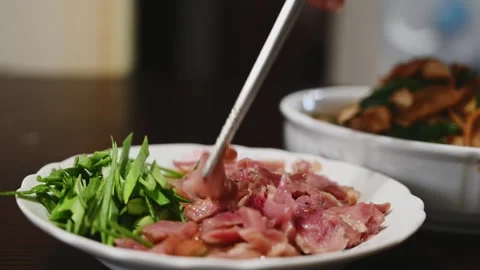 Arranging Yilan Cured Duck with Sliced Green Garlic Video stock 346488640