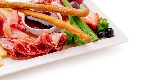 Array of assorted meats and fresh vegetables presented on a platter Stock Photos