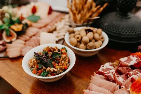 Array of assorted snacks are arranged on a wooden table top Foto stock