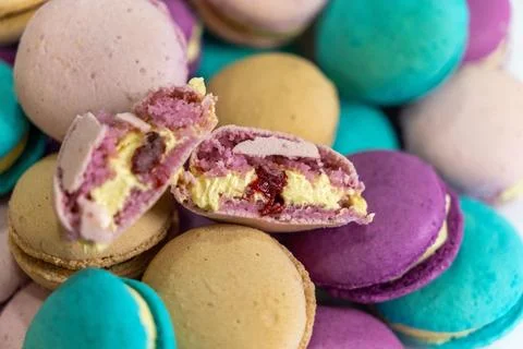 Array of baked macarons with a variety of vibrant colors, including yellow and p Stock Photos