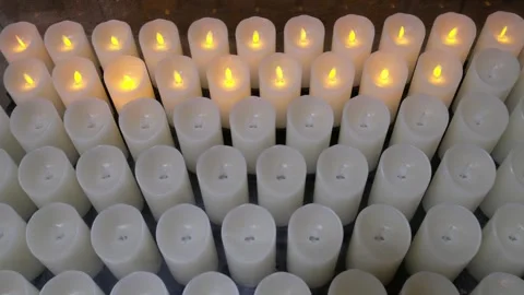 Array of Battery Operated Candles Flicker in the Dim Light. 70 char max Stock Footage 328480069