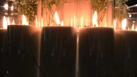 An array of beautifully arranged candles surrounded by delicate flowers Stock Footage 326958892
