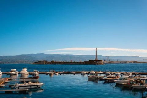 Array of boats docked at a pier situated on a tranquil body of water, providing 스톡 사진