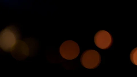 An array of bokeh lights turning and twirling in a disoriented  abstract 動画素材 129947494