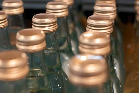An array of bottles with aluminum caps.  Stock Photos