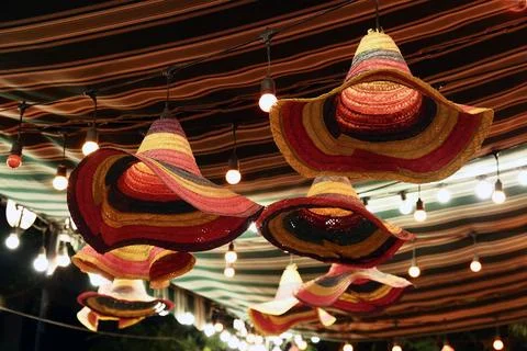 Array of bright, vibrant knitted hats and lightbulbs. Stock Photos