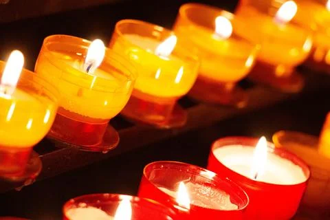 Array of candles or tealights in church with red exterior Stock Photos