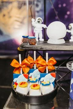 Array of colorful cake pops with rocket designs on a countertop 写真素材