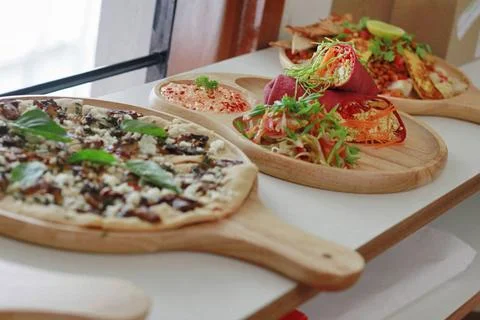 Array of colorful delicious pizza, tofu wrap and salads Array of colorful ... Stock Photos