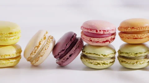 An array of colorful macarons is arranged in a row on a white background  Stock Footage 321844176