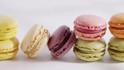 An array of colorful macarons is arranged in a row on a white background  Stock Footage 321850230