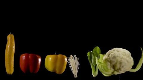 Array of colorful organic vegetables spin in fast motion on black Stock Footage 120714836
