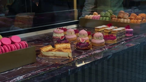 An Array of Colorful Pastries and Delicate Macarons Artfully Displayed in the Stock Footage 318556720