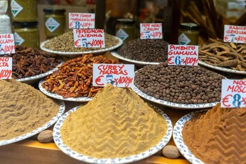 An array of colorful spices, including curry, cayenne pepper, and allspice Stock Photos