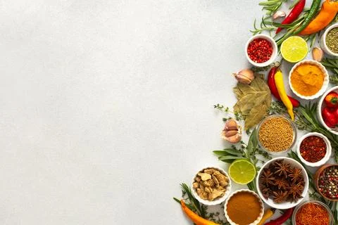 An array of culinary herbs and spices arranged on a gray background, adding.. Stock Photos