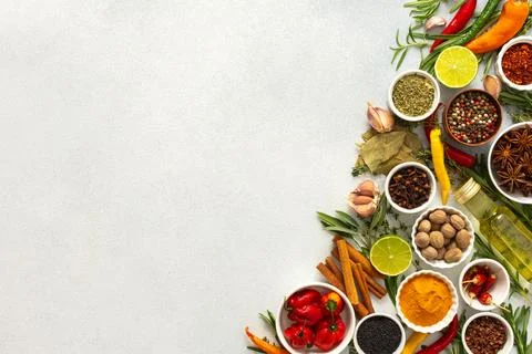 An array of culinary herbs and spices arranged on a gray background, adding.. Stock Photos