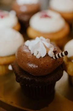 Array of cupcakes adorned with white frosting Stock Photos
