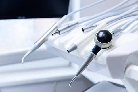 An Array of Dental Tools and Instruments on a Treatment Chair Highlighting the Stock Photos
