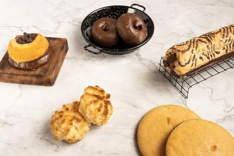 Array of different gourmet pastries on a kitchen table Stock Photos