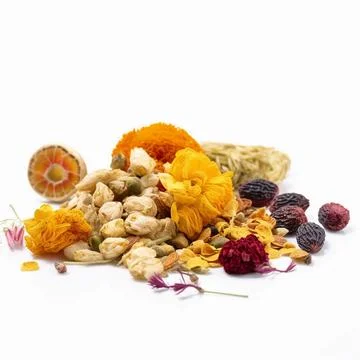 Array of dried herbs and spices is displayed on a white background Foto stock
