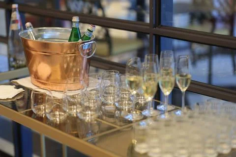 Array of glasses including champagne flutes, with other drinks on the bucket Foto stock