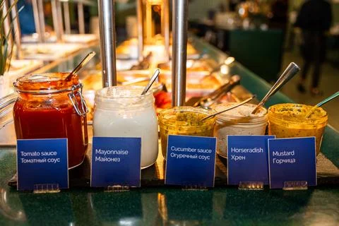 Array of Gourmet Sauces and Condiments at a Hotel Buffet Station Stock Photos