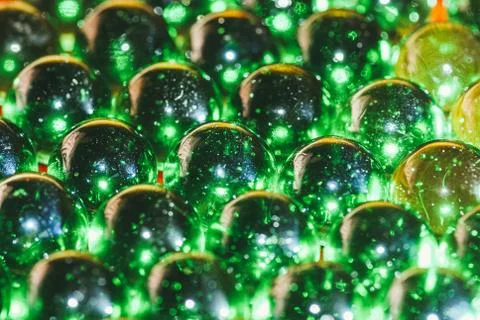 An array of green glass balls covered with dust and chips from old age Stock Photos