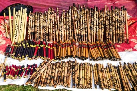 Array of Handcrafted Flutes Displayed at a Cultural Festival Outdoors Stock Photos