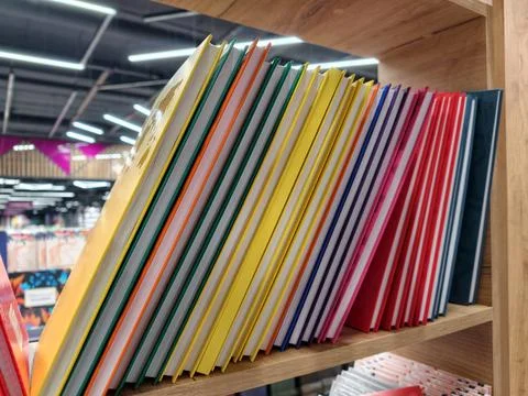 An array of hardcover notebooks in multiple colors, ready for sale on a sup.. Stock Photos