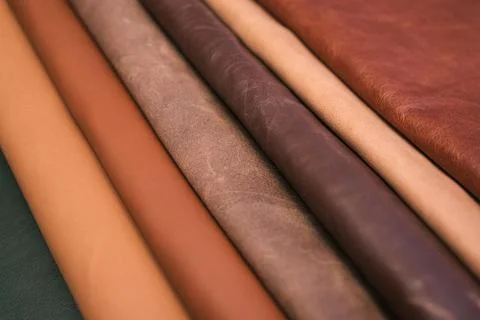 Array of leather fabric samples in different shades neatly placed on a table, re Fotos de archivo