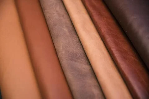 Array of leather fabric samples in different shades neatly placed on a table, re 写真素材