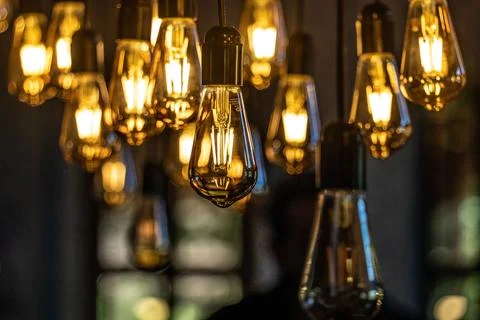 An array of light bulbs on a pole in a room Stock Photos